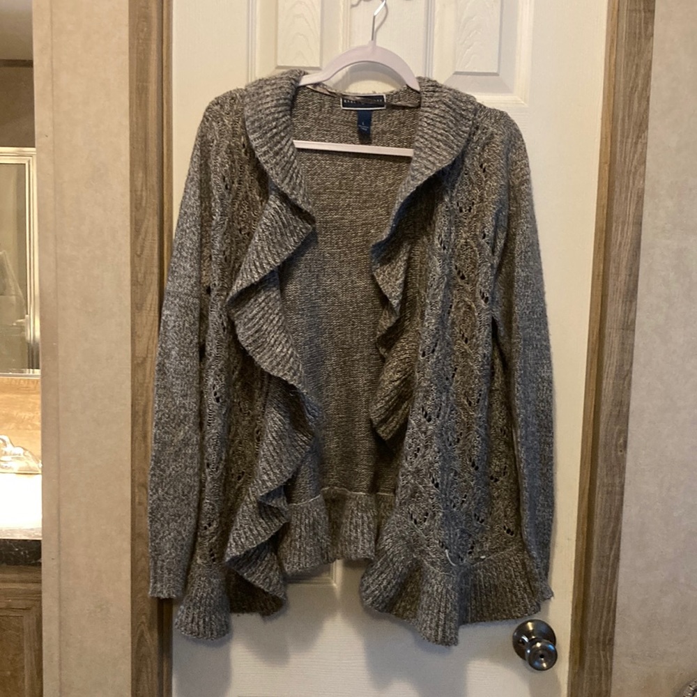 Gray sweater with front ruffle.